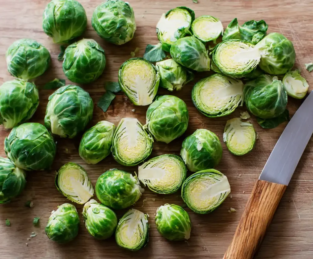 Fresh Brussels sprouts trimmed and halved on cutting board for air fryer recipe
