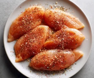 Raw chicken breasts seasoned with paprika, garlic, and pepper for Instant Pot BBQ Chicken
