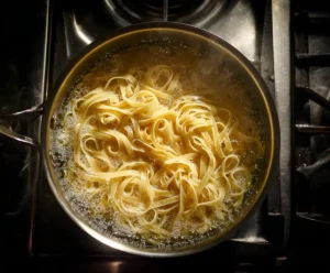 Fettuccine pasta cooking in salted boiling water for Alfredo recipe