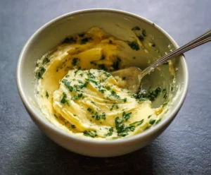 Garlic butter mixture with parsley and Parmesan in bowl