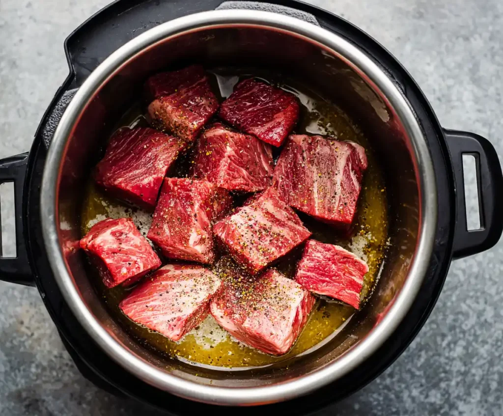 Beef chuck roast searing in pressure cooker for pot roast recipe