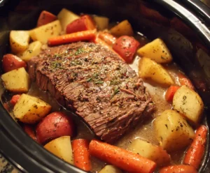 Beef roast in slow cooker with broth and vegetables