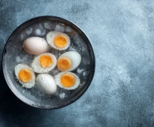 Hard-boiled eggs cooling in ice water bath