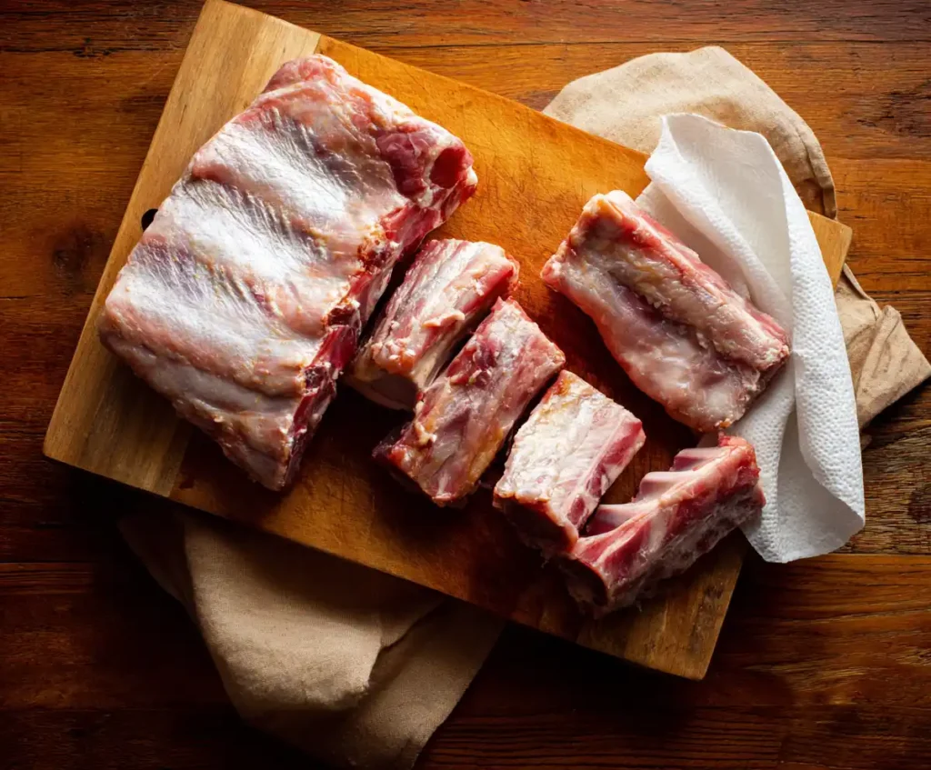 Raw pork ribs with silver skin removed for slow cooker BBQ ribs prep