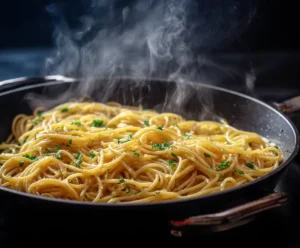 Spaghetti tossed with lemon garlic sauce in skillet